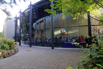 A view from outside the Chan Centre into the busy lobby during Orientation